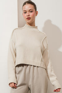 EXPOSED SEAM MOCK NECK SWEATER